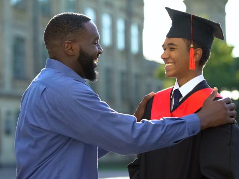A father and son celebrate his graduation.