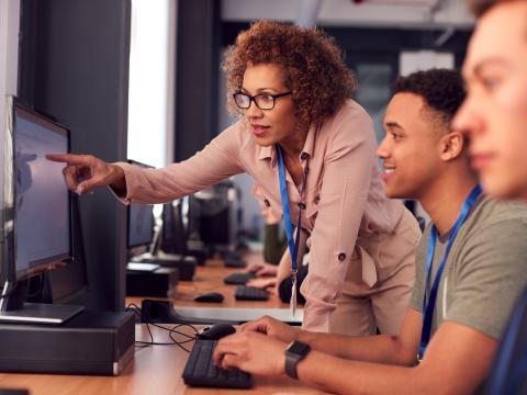 Teacher helping students