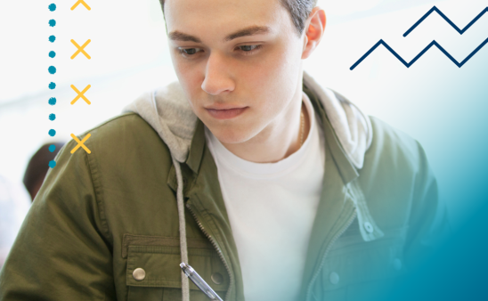 A male student studies while reading a book. A blue design outlines the photo.
