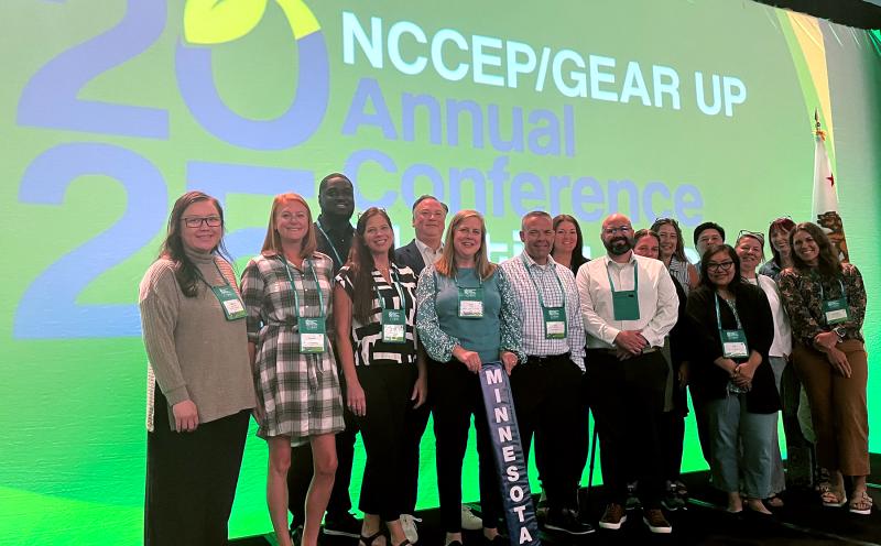 A group of coworkers stand in front of a screen that reads "2025 NCCEP Conference"